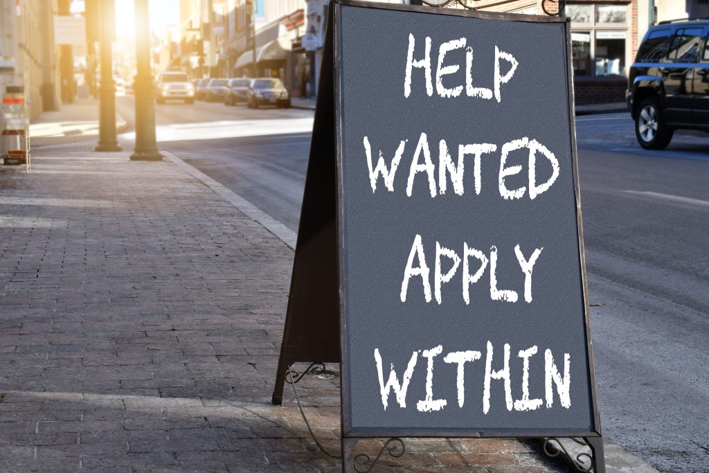 How to Beat the Small Business Staff Shortage - Chalk sign out the front of a shop that reads "Help Wanted Apply Within"
