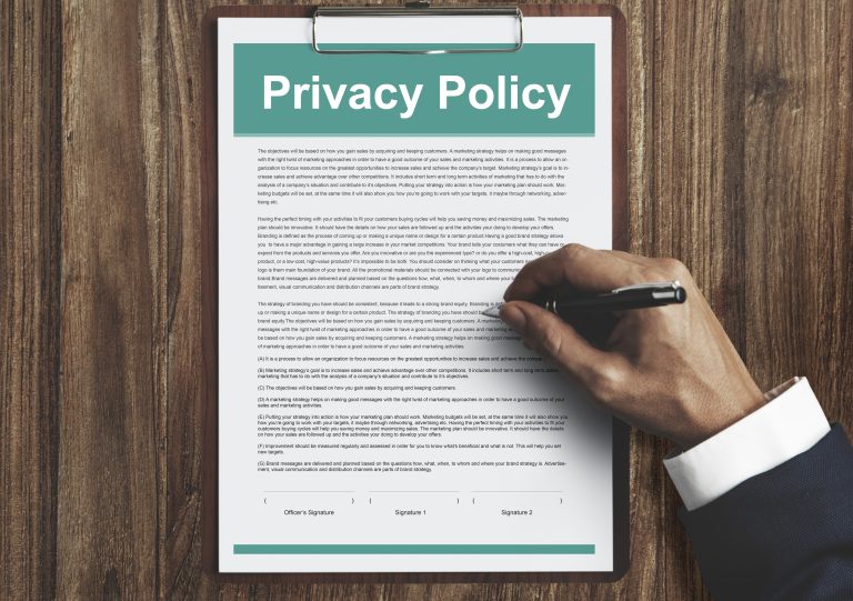 Document on a clipboard highlighting a privacy policy